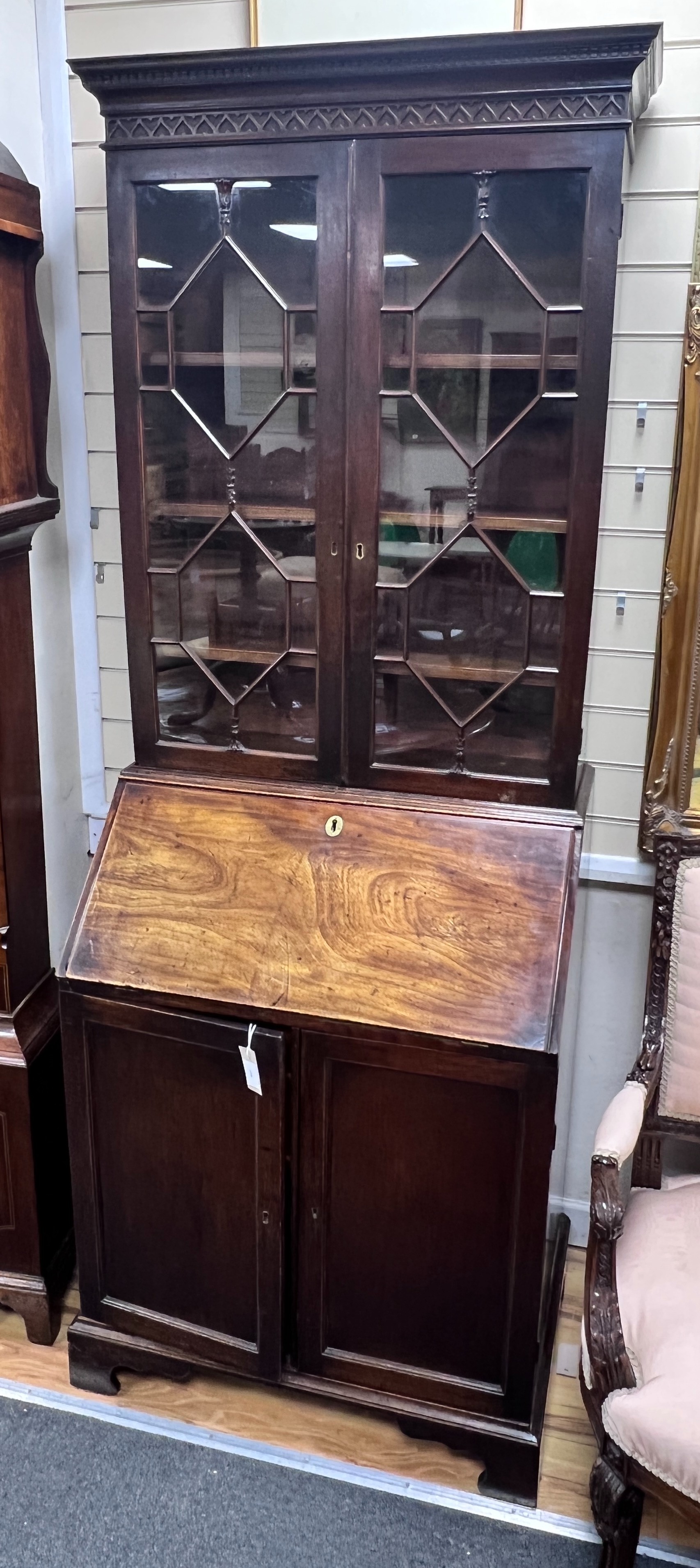 A George III mahogany bureau bookcase of narrow proportions with panelled cupboard base, width 77cm, depth 52cm, height 209cm